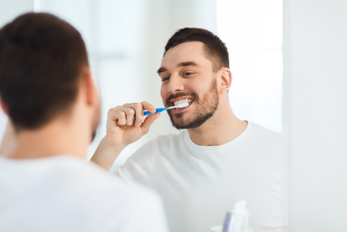 a man brushing his teeth